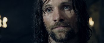 Movie still from “The Lord of the Rings: The Two Towers” (2002), directed by Peter Jackson – A person with wet hair and blue eyes; Close Up shot, Over the shoulder angle