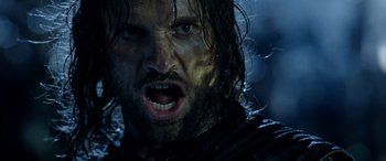Movie still from “The Lord of the Rings: The Two Towers” (2002), directed by Peter Jackson – A person with wet hair and a beard; Close Up shot, Low angle