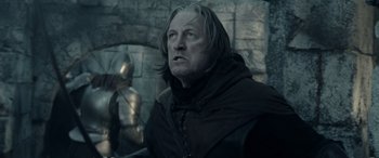 Movie still from “The Lord of the Rings: The Two Towers” (2002), directed by Peter Jackson – A person wearing a robe; Medium shot, Low angle