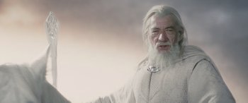 Movie still from “The Lord of the Rings: The Two Towers” (2002), directed by Peter Jackson – An old man with long white hair and a white beard; Medium shot, Low angle