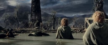 Movie still from “The Lord of the Rings: The Two Towers” (2002), directed by Peter Jackson – A woman sitting in the middle of a river; Wide shot, High angle