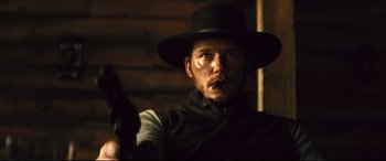 Movie still from “The Magnificent Seven” (2016), directed by Antoine Fuqua – A man with a hat and a gun in his hand; Close Up shot, Low angle