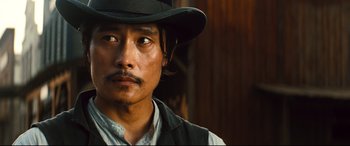 Movie still from “The Magnificent Seven” (2016), directed by Antoine Fuqua – A person wearing a hat; Close Up shot, Low angle