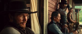 Movie still from “The Magnificent Seven” (2016), directed by Antoine Fuqua – A man in a cowboy hat and a man with a beard; Close Up shot, Over the shoulder angle