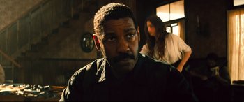 Movie still from “The Magnificent Seven” (2016), directed by Antoine Fuqua – A person wearing a black shirt; Close Up shot, Over the shoulder angle
