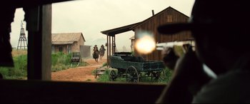 Movie still from “The Magnificent Seven” (2016), directed by Antoine Fuqua – Two men on horses are riding in a field; Wide shot, Over the shoulder angle