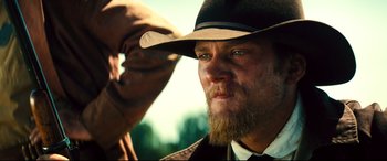 Movie still from “The Magnificent Seven” (2016), directed by Antoine Fuqua – A man with a long beard wearing a hat; Close Up shot, Low angle