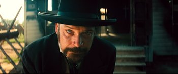 Movie still from “The Magnificent Seven” (2016), directed by Antoine Fuqua – A person wearing a hat; Close Up shot, Low angle