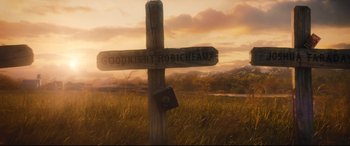 Movie still from “The Magnificent Seven” (2016), directed by Antoine Fuqua – A wooden cross in the middle of a grassy field; Wide shot, Low angle