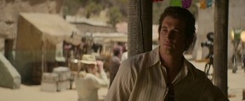 Movie still from “The Offer” (2022), directed by Dexter Fletcher – A person wearing a striped shirt; Medium shot, Over the shoulder angle