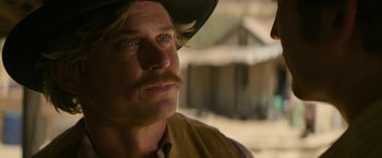 Movie still from “The Offer” (2022), directed by Dexter Fletcher – A person wearing a cowboy hat; Close Up shot, Over the shoulder angle