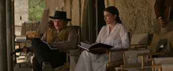 Movie still from “The Offer” (2022), directed by Dexter Fletcher – A man and a woman sitting next to each other; Medium shot, Over the shoulder angle