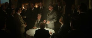 Movie still from “The Offer” (2022), directed by Dexter Fletcher – A group of men sitting around a round table; Medium shot, Over the shoulder angle