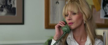 Movie still from “The Offer” (2022), directed by Dexter Fletcher – A woman is talking on a phone while sitting in front of a mirror; Close Up shot, Low angle