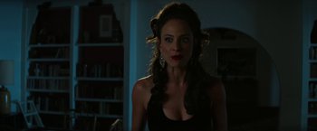 Movie still from “The Offer” (2022), directed by Dexter Fletcher – A woman in a black top is standing in a dark room; Close Up shot, Over the shoulder angle