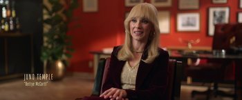 Movie still from “The Offer” (2022), directed by Dexter Fletcher – A woman sitting in a chair in a room; Close Up shot, Over the shoulder angle