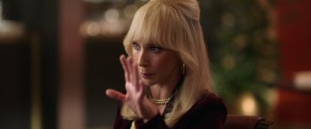 Movie still from “The Offer” (2022), directed by Dexter Fletcher – A woman with blond hair and a gold necklace claps her hands; Close Up shot, Over the shoulder angle