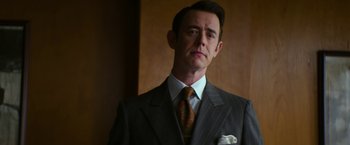 Movie still from “The Offer” (2022), directed by Dexter Fletcher – A person wearing a suit and tie; Close Up shot, Low angle