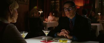 Movie still from “The Offer” (2022), directed by Dexter Fletcher – A man sitting at a table with a glass of wine; Medium shot, Over the shoulder angle
