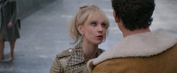 Movie still from “The Offer” (2022), directed by Dexter Fletcher – A woman wearing a leopard print jacket talking to a man wearing a shearling jacket; Close Up shot, Over the shoulder angle