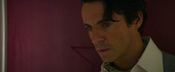Movie still from “The Offer” (2022), directed by Dexter Fletcher – A person with long black hair; Close Up shot, Over the shoulder angle