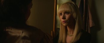 Movie still from “The Offer” (2022), directed by Dexter Fletcher – A woman looking into a mirror while wearing a gold necklace; Close Up shot, Over the shoulder angle
