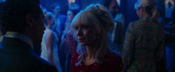 Movie still from “The Offer” (2022), directed by Dexter Fletcher – A woman in a red dress in front of a group of people; Close Up shot, Over the shoulder angle