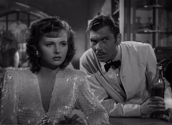 Movie still from “Casablanca” (1942), directed by Michael Curtiz – A man and a woman sitting next to each other in a room; Close Up shot, Over the shoulder angle