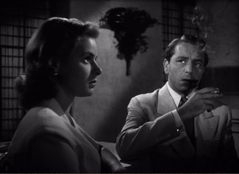 Movie still from “Casablanca” (1942), directed by Michael Curtiz – A man and a woman are smoking a cigarette together; Close Up shot, Over the shoulder angle