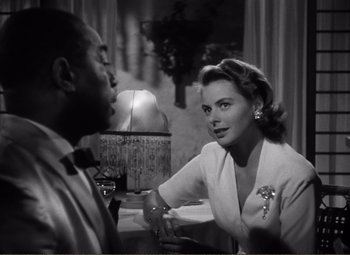 Movie still from “Casablanca” (1942), directed by Michael Curtiz – A man and a woman sitting at a dinner table; Close Up shot, Over the shoulder angle