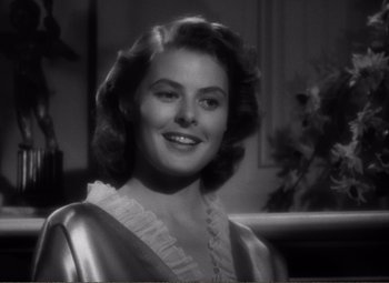 Movie still from “Casablanca” (1942), directed by Michael Curtiz – A black - and - white photo of a woman smiling; Close Up shot, Over the shoulder angle