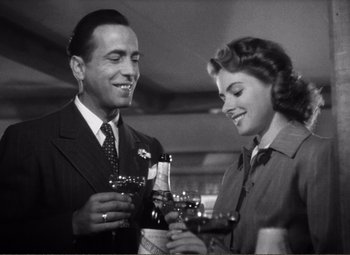 Movie still from “Casablanca” (1942), directed by Michael Curtiz – A man and a woman are holding wine glasses; Close Up shot, Low angle