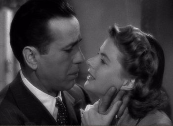 Movie still from “Casablanca” (1942), directed by Michael Curtiz – A man and a woman kissing each other in a black and white photo; Close Up shot, High angle