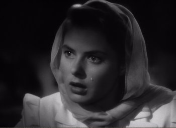 Movie still from “Casablanca” (1942), directed by Michael Curtiz – A black - and - white photo of a woman with a scarf around her neck; Close Up shot, Low angle