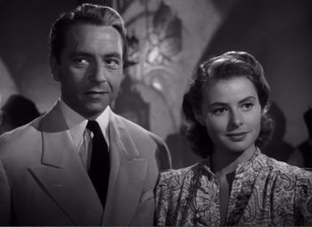 Movie still from “Casablanca” (1942), directed by Michael Curtiz – A man and a woman standing next to each other in front of a clock; Close Up shot, Low angle