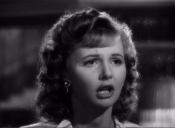 Movie still from “Casablanca” (1942), directed by Michael Curtiz – A young woman with a surprised look on her face; Close Up shot, Over the shoulder angle