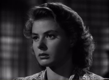 Movie still from “Casablanca” (1942), directed by Michael Curtiz – A black - and - white photo of a woman crying; Close Up shot, Low angle