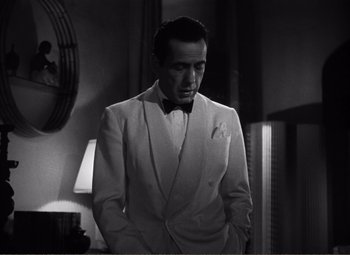 Movie still from “Casablanca” (1942), directed by Michael Curtiz – A black and white photo of a man in a suit; Medium shot, Low angle