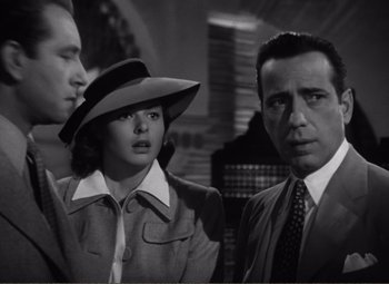 Movie still from “Casablanca” (1942), directed by Michael Curtiz – Two men and a woman standing next to each other; Close Up shot, Low angle