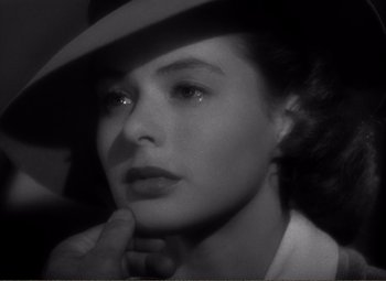 Movie still from “Casablanca” (1942), directed by Michael Curtiz – A black - and - white photo of a woman in a hat; Close Up shot, Over the shoulder angle