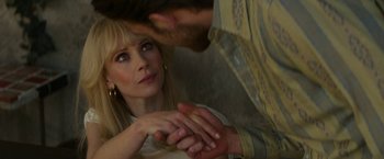 Movie still from “The Offer” (2022), directed by Dexter Fletcher – A woman sitting on a man's lap while holding her hands; Close Up shot, Over the shoulder angle