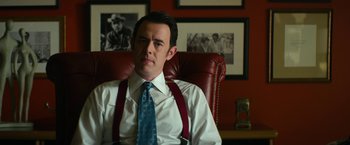 Movie still from “The Offer” (2022), directed by Dexter Fletcher – A man sitting in an office chair wearing a tie; Medium shot, Over the shoulder angle