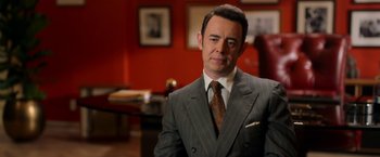 Movie still from “The Offer” (2022), directed by Dexter Fletcher – A man wearing a suit and tie in a room; Close Up shot, Over the shoulder angle