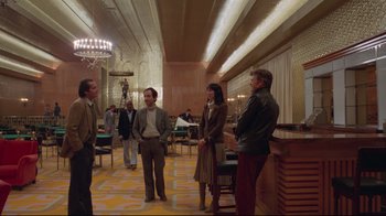 Movie still from “The Shining” (1980), directed by Stanley Kubrick – A group of people standing around in a room; Wide shot, Over the shoulder angle