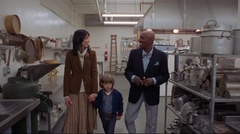 Movie still from “The Shining” (1980), directed by Stanley Kubrick – A man and a woman and a child in a kitchen; Medium shot, Low angle