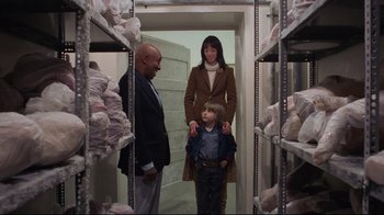 Movie still from “The Shining” (1980), directed by Stanley Kubrick – A man and a woman and a child in a room; Medium shot, Over the shoulder angle