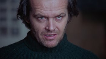 Movie still from “The Shining” (1980), directed by Stanley Kubrick – A person wearing a green sweater; Close Up shot, Low angle