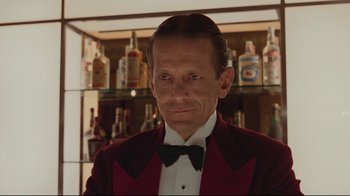 Movie still from “The Shining” (1980), directed by Stanley Kubrick – A person wearing a suit and bow tie; Close Up shot, Low angle