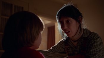 Movie still from “The Shining” (1980), directed by Stanley Kubrick – A woman and a child in a dark room; Close Up shot, Over the shoulder angle