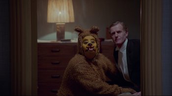 Movie still from “The Shining” (1980), directed by Stanley Kubrick – A man and a woman dressed up as a dog and a bear; Medium shot, Over the shoulder angle